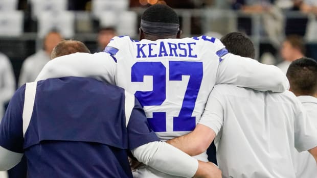Cowboys safety Jayron Kearse is helped off the field during pregame warm-ups after injuring his left knee.